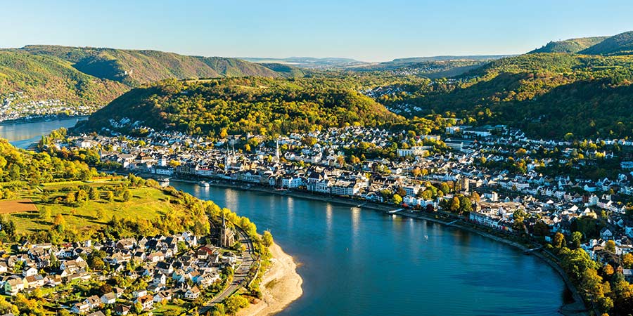 The majestic Rhine Gorge curves through the landscape of traditional German towns and green forest land. 